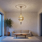 Aksil pendant hung low over a kitchen island in a modern interior