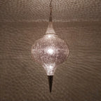 Close detail of the lit Aksil, warm light through hand-punched circles