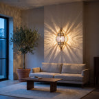Amalu brass sconce lit above a console in a modern entryway