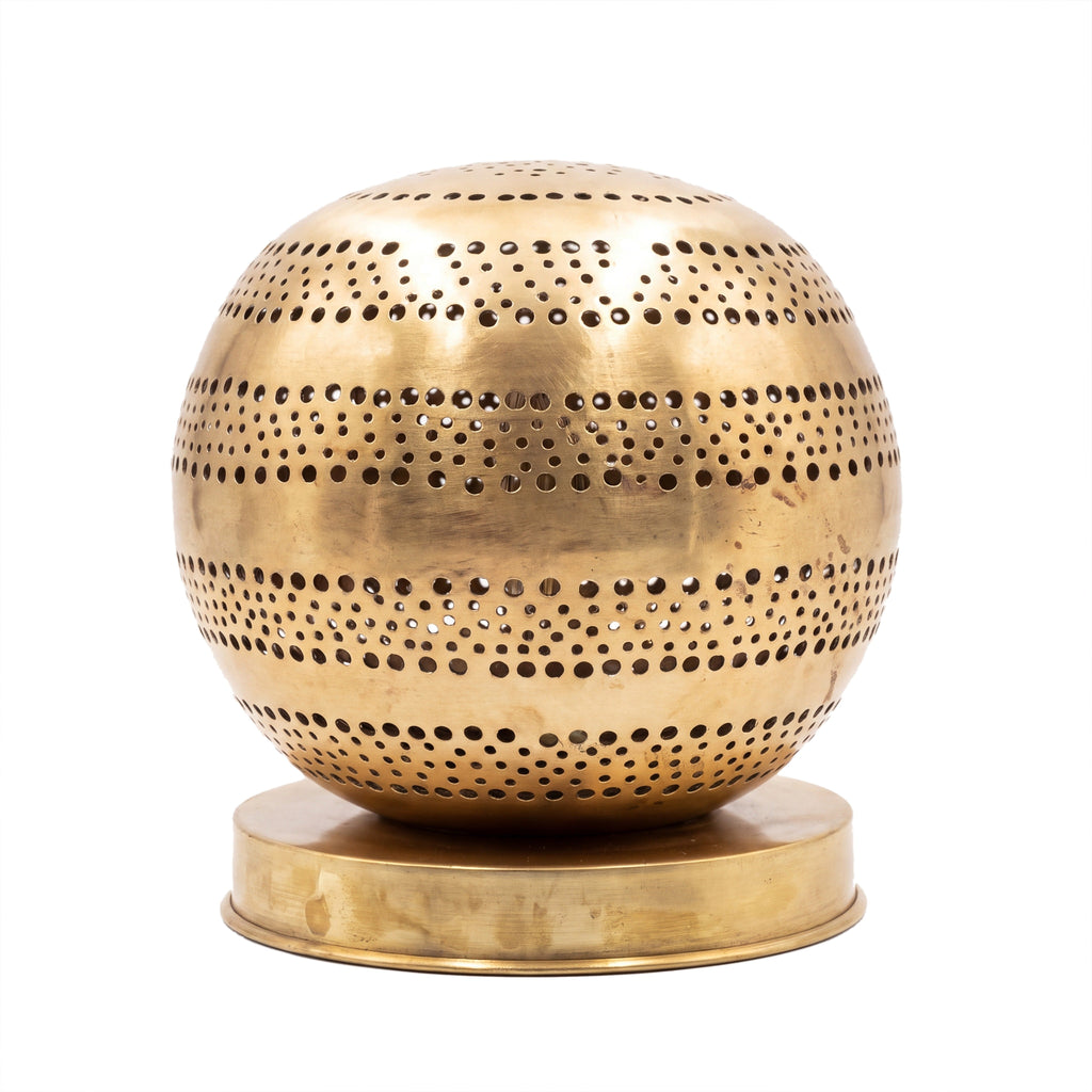 Aman pierced brass ball table lamp on a white studio background