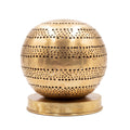 Aman pierced brass ball table lamp on a white studio background