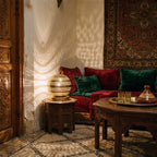 Aman lamp glowing in a riad at night, a constellation of light on the walls