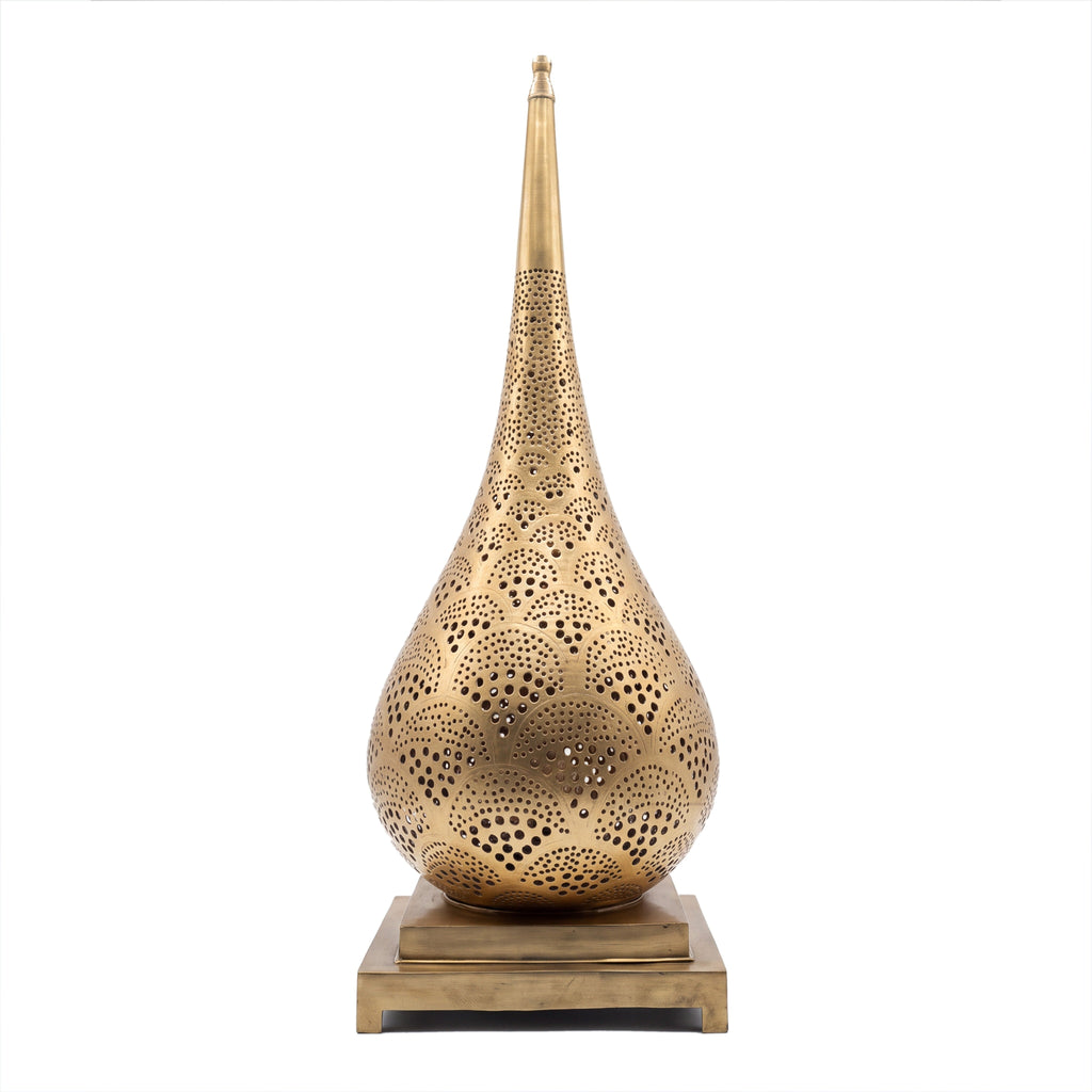 Anbar tall pierced brass table lamp on a seamless white studio background