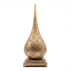 Anbar tall pierced brass table lamp on a seamless white studio background