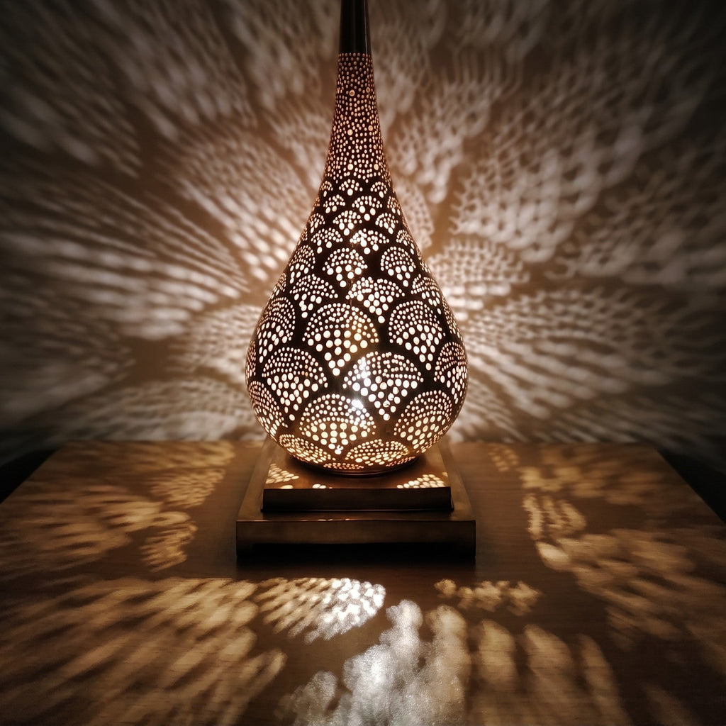 Detail of the lit Anbar lamp, amber light through hand-cut brass piercing