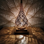 Detail of the lit Anbar lamp, amber light through hand-cut brass piercing