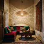 Anfa pendant glowing in a Moroccan riad salon at night