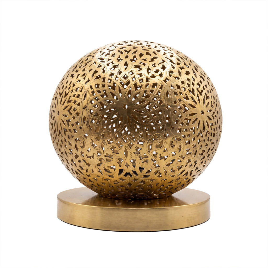 Ayyur engraved and pierced brass ball table lamp on a white studio background