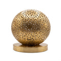 Ayyur engraved and pierced brass ball table lamp on a white studio background