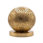 Ayyur engraved and pierced brass ball table lamp on a white studio background