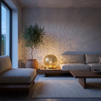 Ayyur brass sphere lamp on a bedside table in a modern bedroom