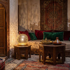 Ayyur lamp glowing like a small moon on a riad table at night
