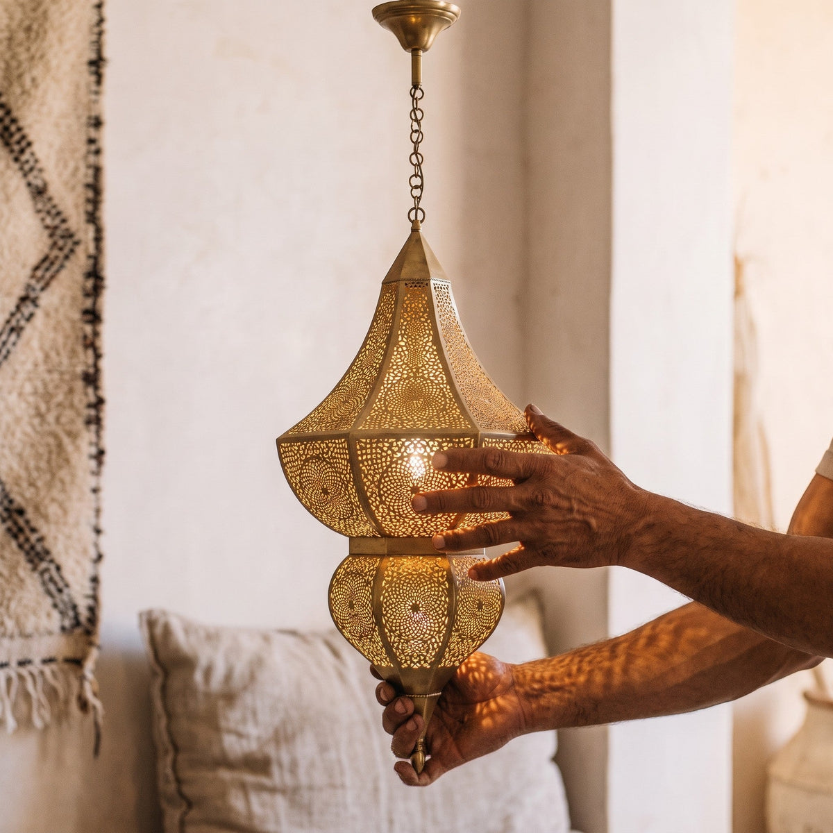 The Badi shade resting in the maker's hands, saw lines visible