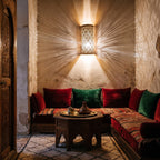 Bahja sconce pair glowing in a lamplit Moroccan riad salon