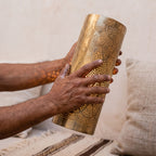 Artisan holding one Bahja pierced brass sconce shade in both hands
