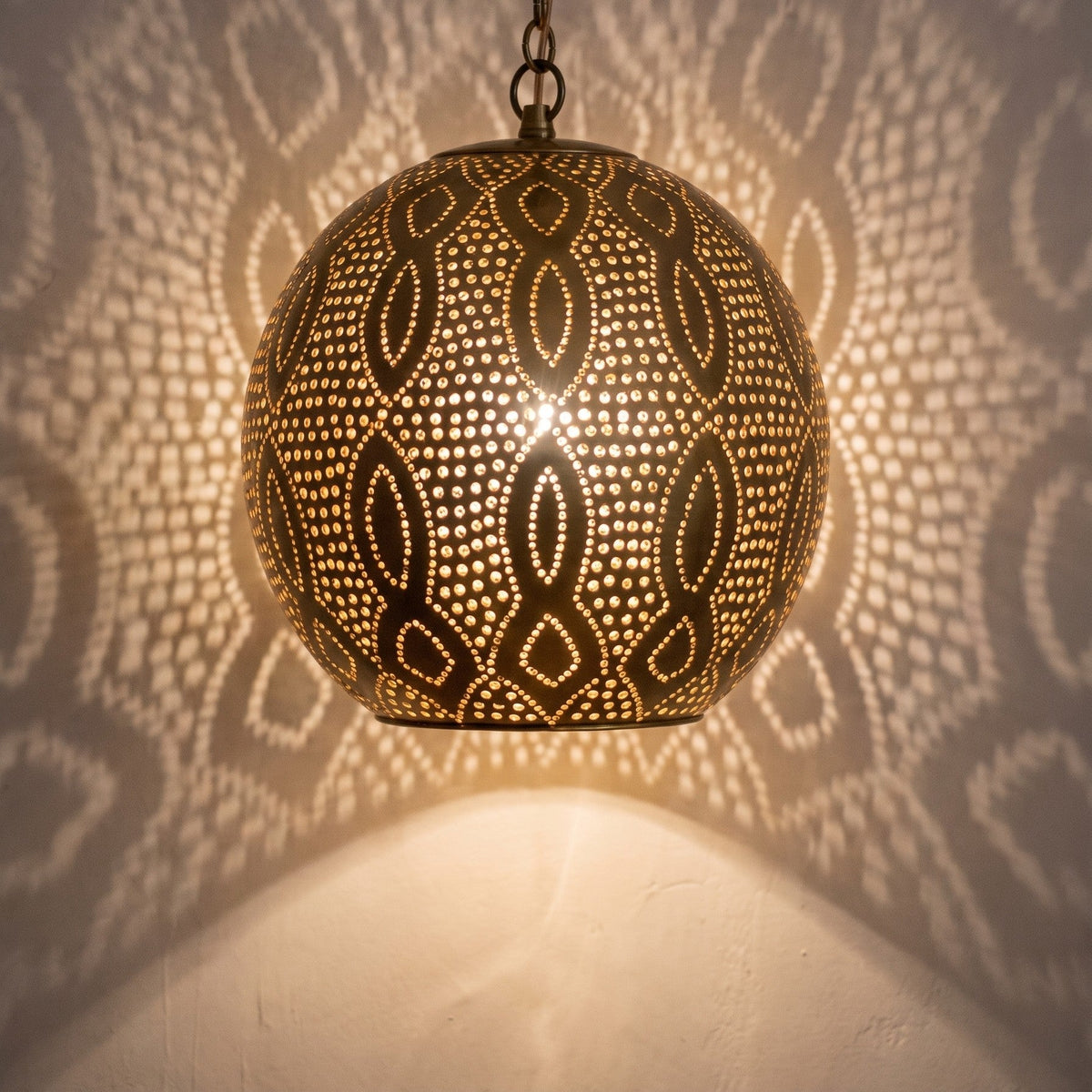 Close-up of the lit Baraka pendant, punched circles glowing