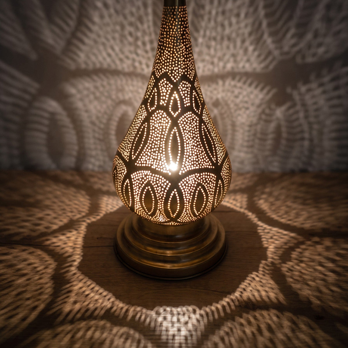 Close-up of Dahab lit, the pierced brass pattern glowing from within