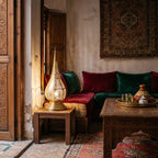 Dahab table lamp lit on a low table in a Moroccan riad in the evening