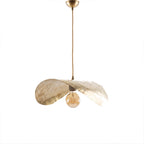 Dahbia hammered brass leaf pendant light on a white studio background