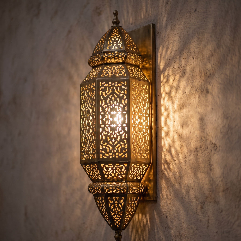 Detail of the lit Fajr sconce, geometric and floral piercing glowing warm