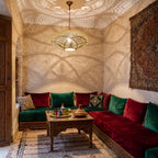 Hana pendant lit at night in a Moroccan riad sitting room