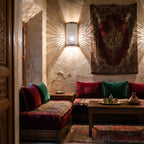 Isli sconce pair lit on a Moroccan riad wall at night
