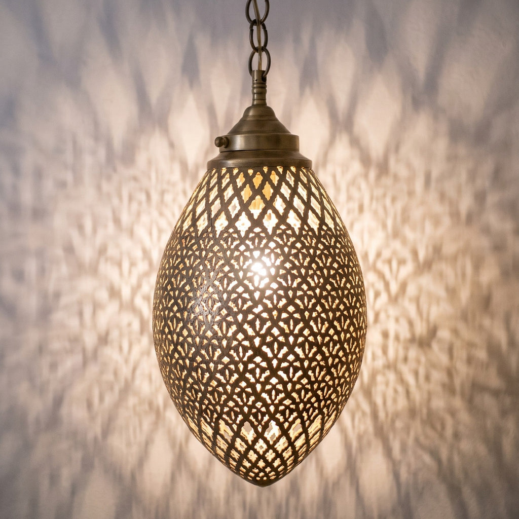 Detail of the lit Kenza pendant, engraving and pierced holes glowing