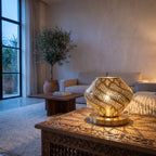 Khzama lantern lit on a sideboard in a modern interior, light through open petals