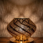Detail of Khzama lit, pierced brass petals glowing from within