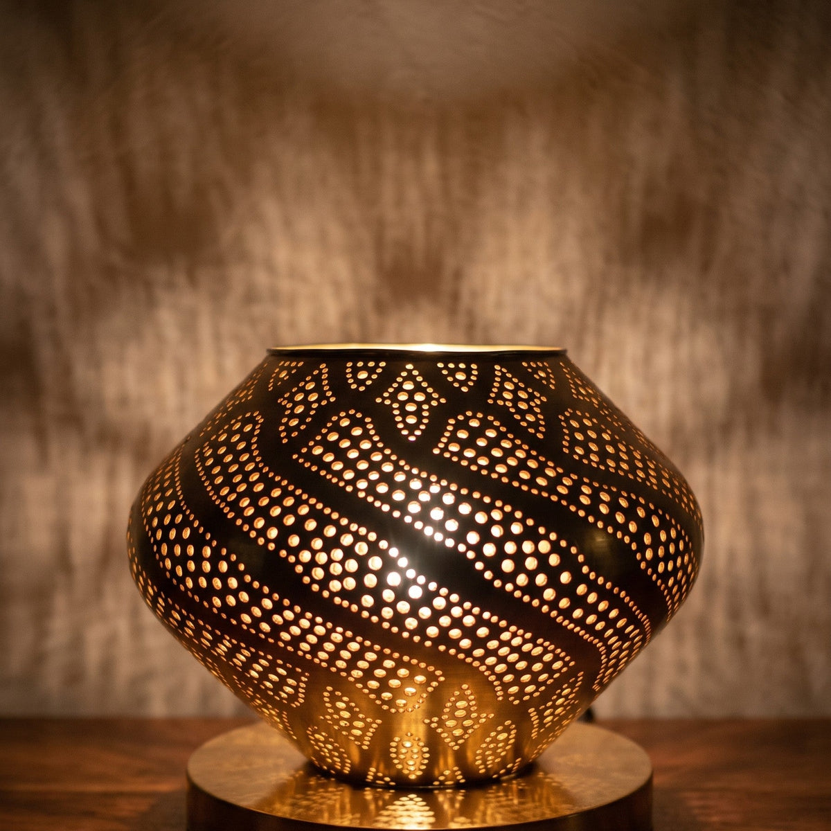 Detail of Khzama lit, pierced brass petals glowing from within