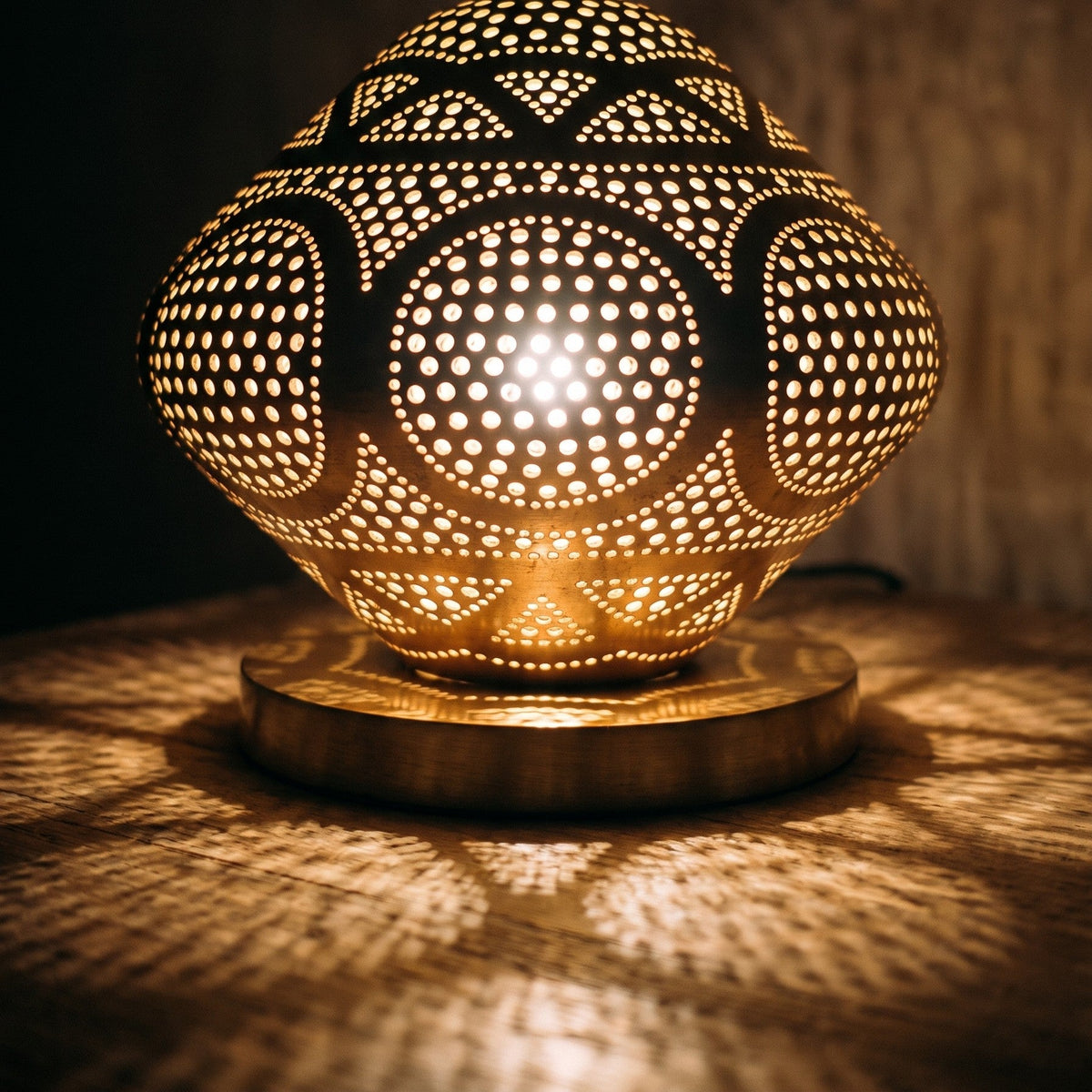 Detail of the lit Louiza dome, pattern of light through pierced brass