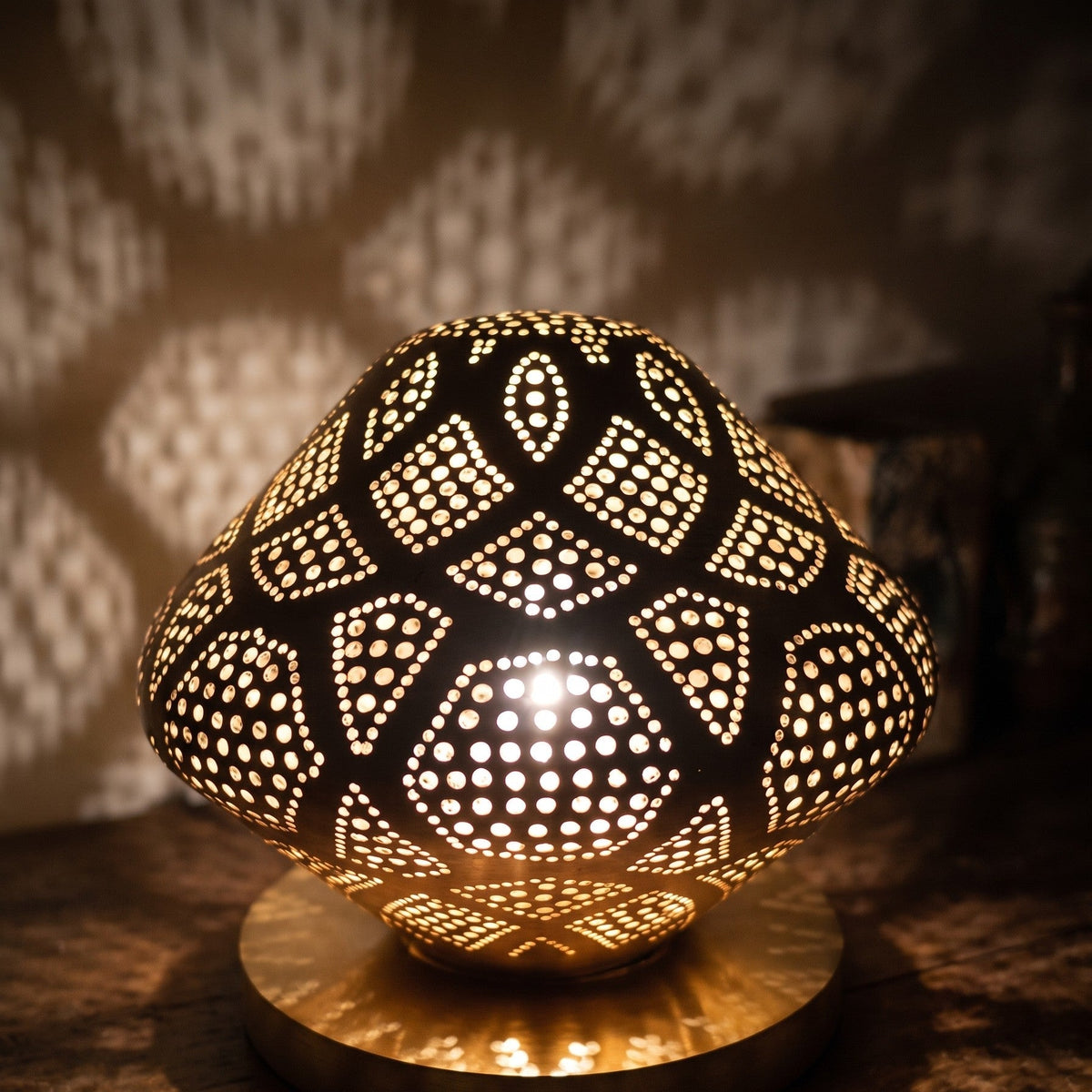 Close-up of the lit Louz dome, light through the pierced brass