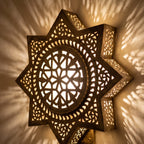 Close view of the lit Najma, geometric piercework glowing