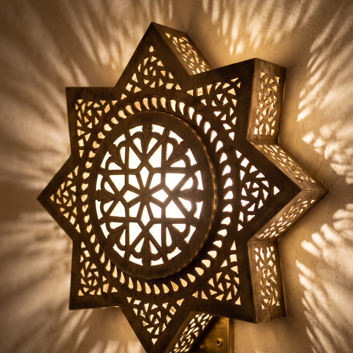 Close view of the lit Najma, geometric piercework glowing