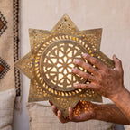 The Najma body held in the maker's hands before finishing