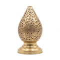 Naqsh brass table lamp pierced with Arabic calligraphy, on a white studio background