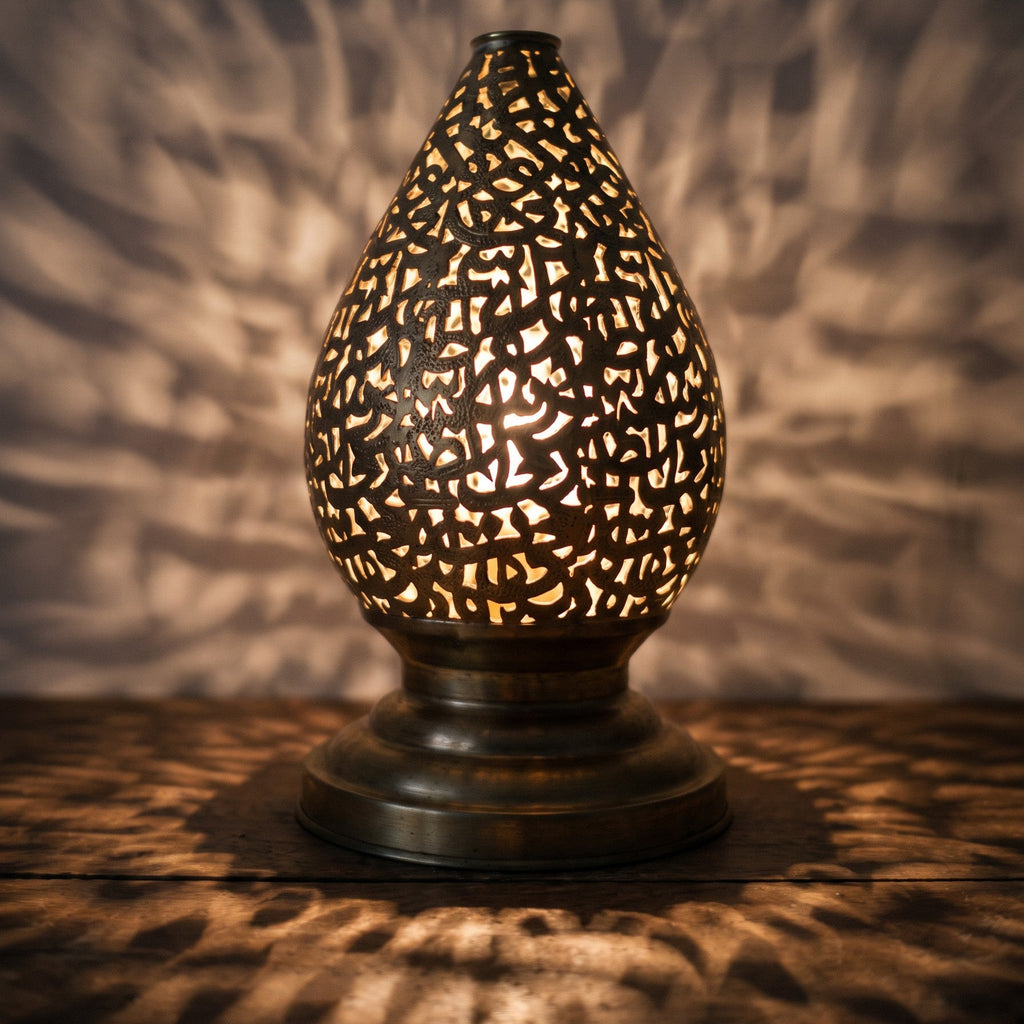 Detail of the lit Naqsh lamp, light passing through hand-cut Arabic letters