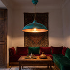 Nila green patina pendant glowing in a Moroccan riad interior