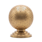 Ourika pierced brass globe table lamp on a white studio background