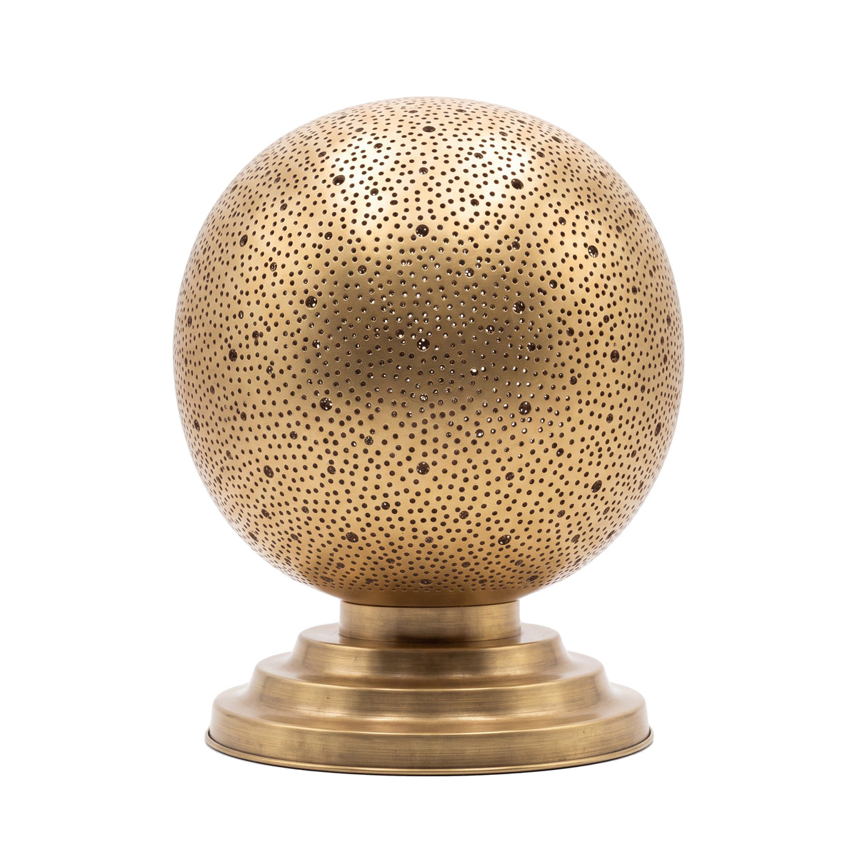 Ourika pierced brass globe table lamp on a white studio background