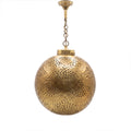 Qamar pendant, a pierced brass ball, on a white studio background