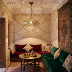 Saada pendant glowing at night in a Moroccan riad