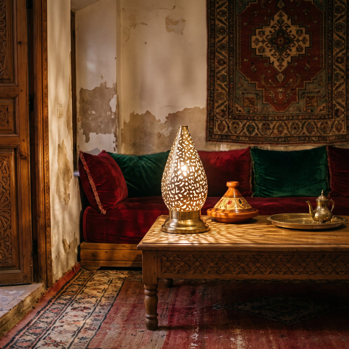 Shama lantern pair glowing on a low table in a Moroccan riad courtyard