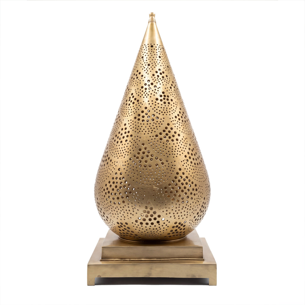 Siraj pierced brass table lantern on a white studio background