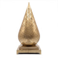 Siraj pierced brass table lantern on a white studio background