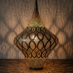 Close view of the lit Skoura lantern, hand-punched pattern glowing