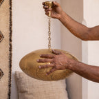 A maalem holding the Souhail dome in both hands in the Marrakech workshop