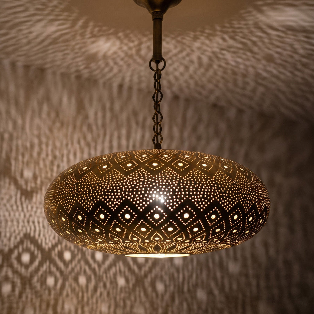 Detail of the lit Tafat pendant, floral piercing glowing