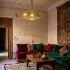 Tafat pendant lit in a Moroccan riad, pattern thrown across the ceiling