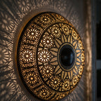 Close detail of the lit Tafraout, punched circles and floral cutwork glowing